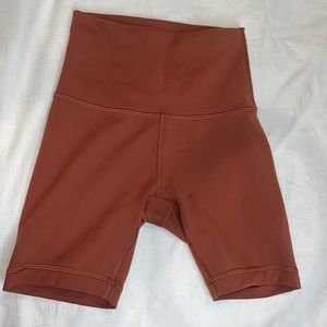 Burt orange colored Lululemon biker shorts in size 2